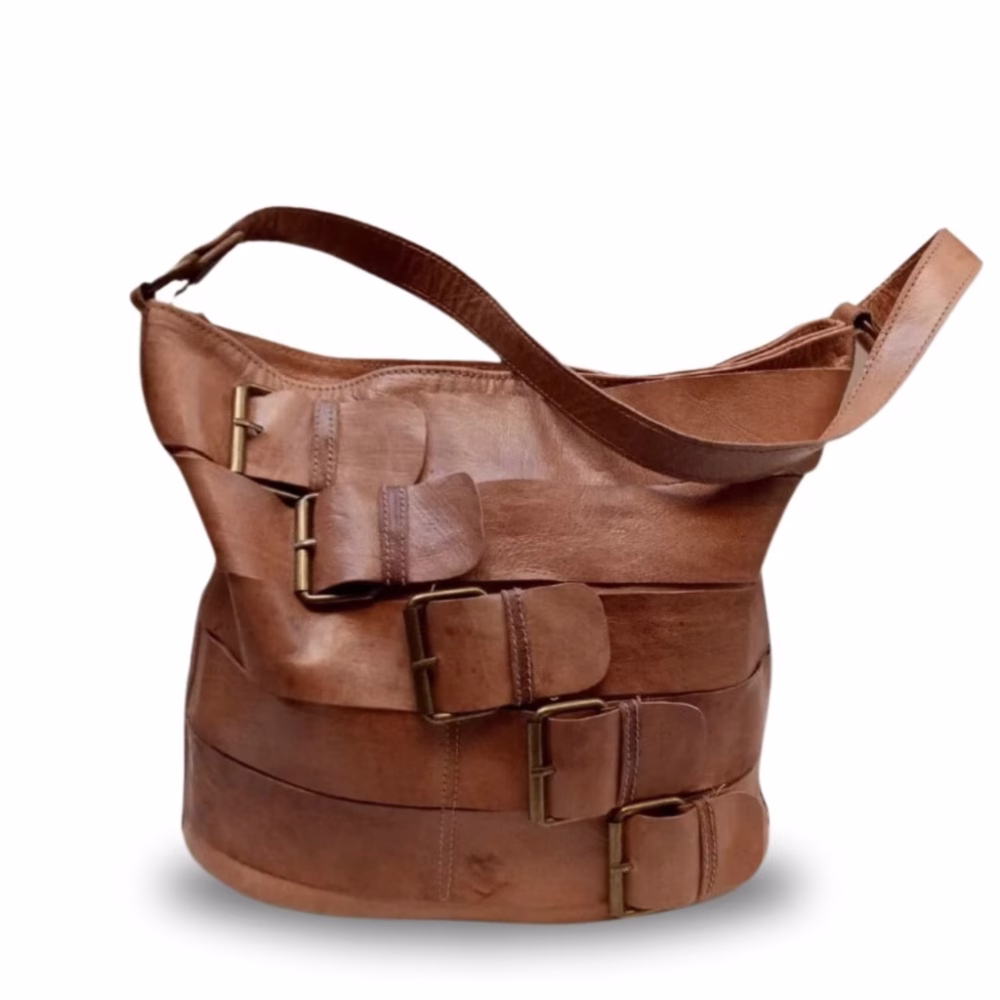 Tan leather tote bag with decorative strap design front view