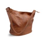 Handcrafted tan leather tote bag in bucket style showing smooth cognac finish and simple strap design