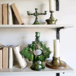 Antique-style ceramic candleholder displayed on bookshelf