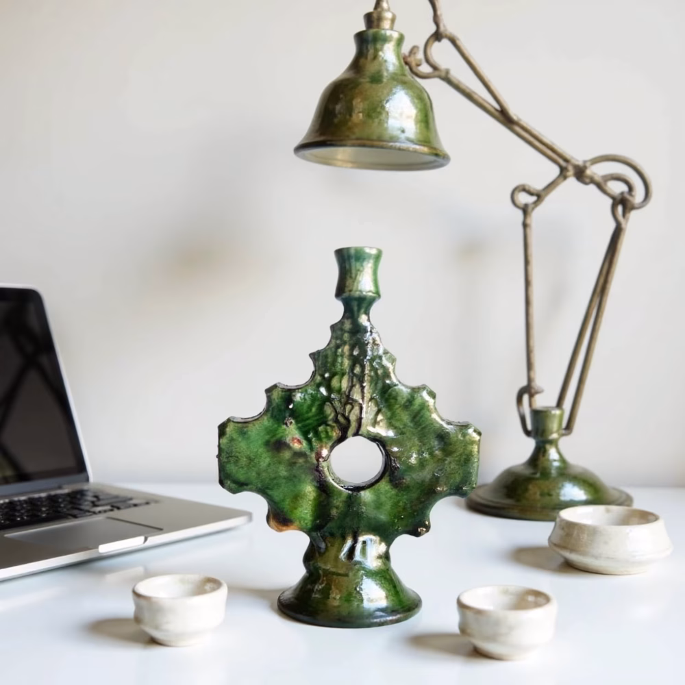Green ceramic cross candleholder with desk lamp