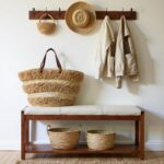 Striped straw bag with long leather handles worn over shoulder in lifestyle setting