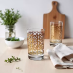Luxury Moroccan tea glasses with gold pattern on wooden board