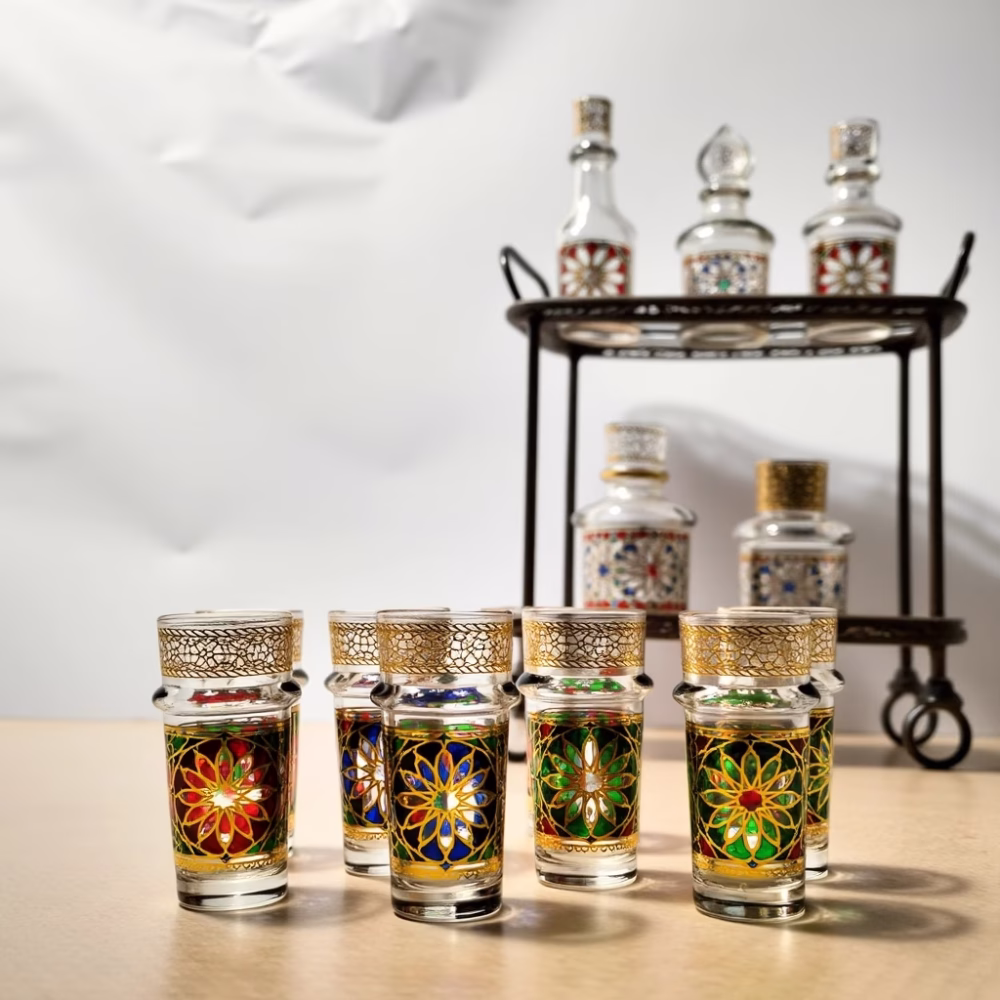 Moroccan tea glasses with ornate designs on silver platter