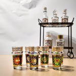 Moroccan tea glasses with ornate designs on silver platter