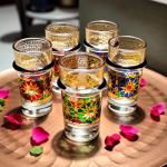 Tea glasses with colorful oriental patterns and rose petals