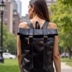 Woman wearing black leather rolltop backpack outdoors