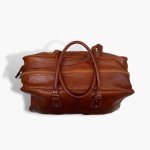 Top view of cognac leather weekend bag showing spacious interior, dual zippers, and handcrafted construction