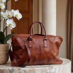 rown leather weekend bag styled with orchids