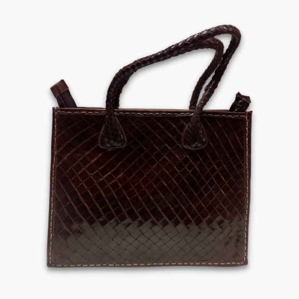 Handwoven leather tote bag flat lay displaying basketweave texture, braided straps, and full-grain leather quality