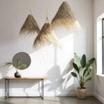 Handwoven palm leaf pendant lights casting warm shadows in contemporary reading nook with chair