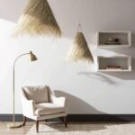 Two handwoven palm leaf pendant lights with natural wheat-blonde fibers in modern kitchen setting