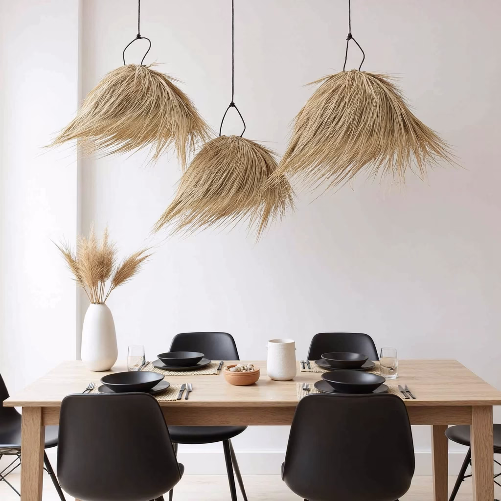 Duo of palm leaf light shades above dining table