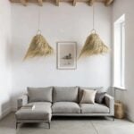 Two handwoven palm leaf pendant lights with organic texture over gray sectional sofa