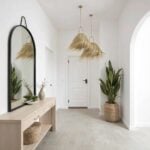 Dual handwoven palm leaf pendant lights creating coastal elegance in contemporary white entryway