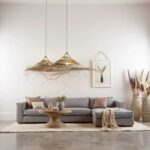 Two tiered palm leaf pendant lights with natural straw texture creating dramatic shadows in neutral living room