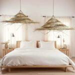 Large three-tiered palm leaf pendant lights with warm glow illuminating modern white marble kitchen island
