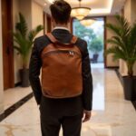 Man in suit carrying brown leather backpack purse in hotel, professional 15.7 inch laptop bag