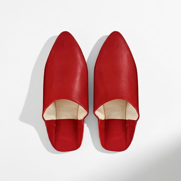 Red handcrafted Moroccan leather slippers with natural interior, traditional babouche with pointed toe styling