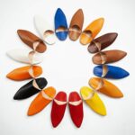 Moroccan leather slippers in vibrant colors arranged in sunburst pattern, handcrafted babouche footwear collection