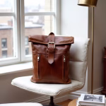 Leather backpack displayed by window in stylish setting