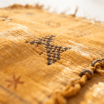 Close-up detail of cactus silk yellow rug showing intricate hand-knotted Berber motifs and texture
