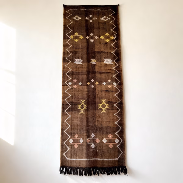 Detailed view of brown cactus silk runner showing intricate diamond and geometric patterns with fringe tassels