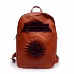 Product shot of handmade leather backpack with sun motif