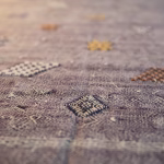 Close-up detail of purple cactus silk rug showing hand-knotted texture and intricate Berber motifs