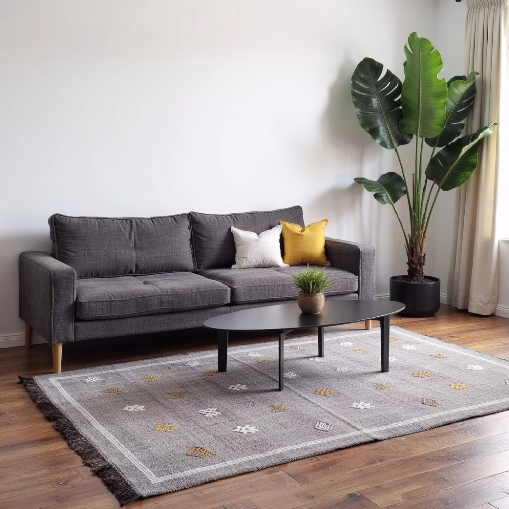 Purple cactus silk rug positioned in contemporary living space with dark furniture and minimalist decor