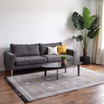 Purple cactus silk rug positioned in contemporary living space with dark furniture and minimalist decor
