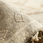 Close-up of handmade cactus rug showing sabra silk texture, fringe detail, and traditional weaving