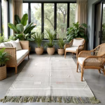 Berber green cactus silk rug in sunroom with natural lighting and abundant plants