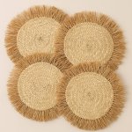 Set of 4 round raffia placemats with golden tassel fringes, handwoven herringbone pattern on neutral background