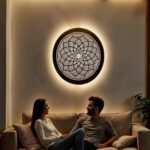 Round brass wall light with hand-engraved mandala pattern casting elegant glow in modern interior