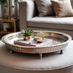 Round brass serving tray with concentric hand-engraved geometric rim patterns and chased banding
