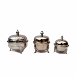 Graduated sizes of silver tea containers with domed lids