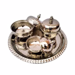 Three-piece tea service arranged on decorative silver tray