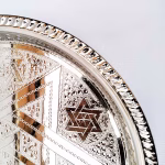 Hand-engraved round platter trays with a Star of David pattern, handmade in Morocco.