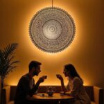 Large brass wall sconce illuminating cozy seating area with intricate geometric patterns