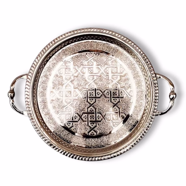 Overhead view of detailed round Moroccan serving tray with handles showing complete geometric pattern