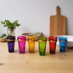 Set of six multicolor beldi tea glasses on wooden table