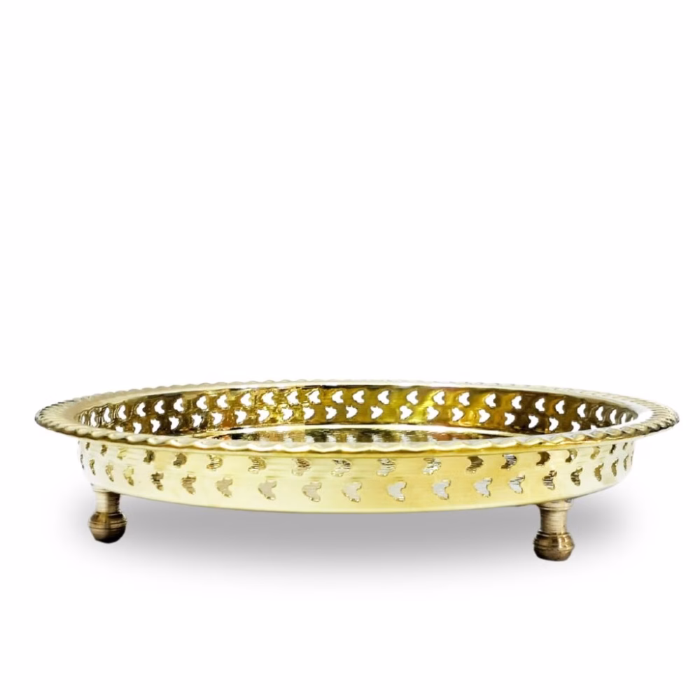 Side profile of an ornate brass circle tray with heart-cut lattice legs, isolated.