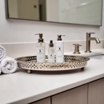 Silver hammered circle tray with decorative rim and feet holding bathroom essentials on vanity counter