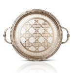 Overhead view of detailed round Moroccan serving tray with handles showing complete geometric pattern