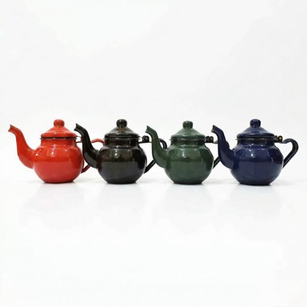 A lineup of four classic Enameled Teapots in varying colors—red, black, green, and blue—displayed in a row against a seamless white studio background.