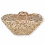 Side view of folded mesh straw shopper bag showing compact storage