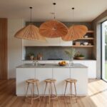 Three handwoven wood pendant lights creating elegant cluster display over modern white kitchen island