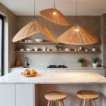 Two large handwoven wood pendant lights with conical shapes illuminating contemporary kitchen workspace