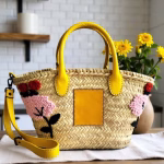 Floral embroidered straw tote with yellow handles styled with spring flowers