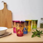 Colorful Moroccan tea glasses arranged with serving board